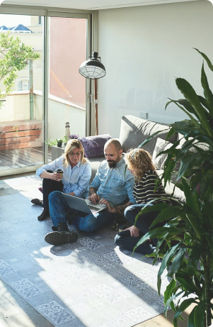 A couple discussing care plans with an adviser at home